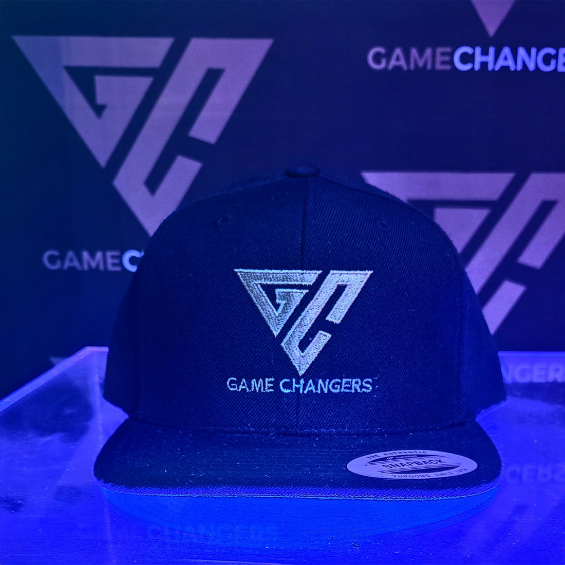Black cap with Game Changers logo on a dark background